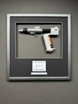 A James Bond Movie Prop Replica in a bespoke Framed Display with an autograph of Roger Moore.